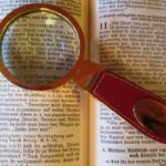 A bible with a magnifying glass
