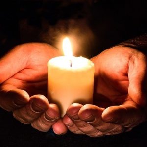 Hands holding a candle